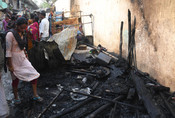 PATNA, MAY 4 (UNI):- People search for their valuables after a fire charred their houses in a slum, Chitkohra area, in Patna on Saturday. UNI PHOTO-95U