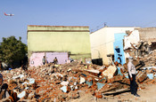 AHMEDABAD, DEC 16 (UNI): Demolition drive underway by Ahmedabad Municipal Corporation (AMC) to remove the illegal residences near Sardar Vallabh Bhai Patel International Airport, in Ahmedabad on Tuesday. UNI Photo 62U