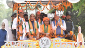 LUCKNOW, APR 29 (UNI):- Defence Minister and BJP candidate for Lucknow Parliamentary seat Rajnath Singh with Uttar Pradesh Chief Minister Yogi Adityanath and Uttarakhand Chief Minister Pushkar Singh Dhami and others on  way to file nomination for the Lok Sabha Election -2024, in Lucknow on Monday.UNI PHOTO-25U